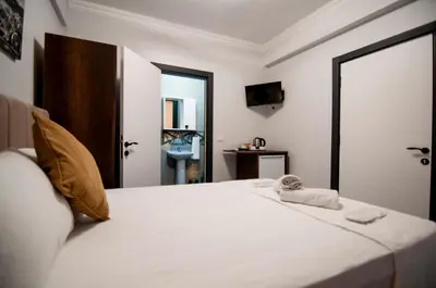 a bedroom with a large white bed with a mirror at CK Boutique Hotel in Istanbul