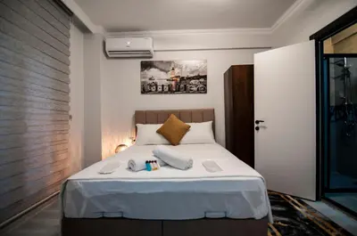 a bedroom with a bed with white sheets at CK Boutique Hotel in Istanbul