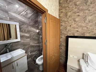a bathroom with a toilet and a sink and a mirror at Gran Brn Hotel Taksim in Istanbul