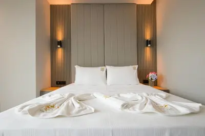 a white bed with two white towels on it at SHERLOCK HOMES HOTELS in Istanbul