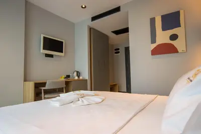 a bedroom with a white bed and a desk at SHERLOCK HOMES HOTELS in Istanbul