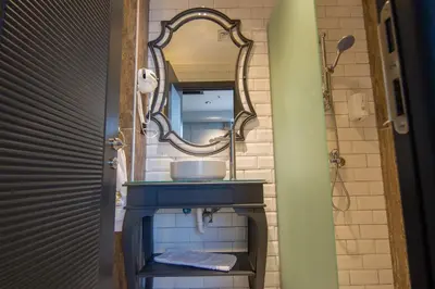 a bathroom with a sink and a mirror at SHERLOCK HOMES HOTELS in Istanbul