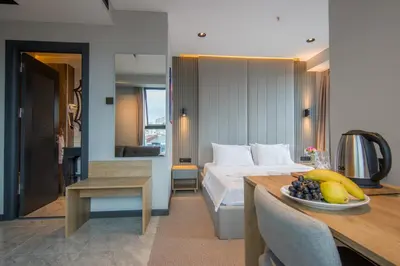 a bedroom with a bed and a table with a bowl of fruit at SHERLOCK HOMES HOTELS in Istanbul
