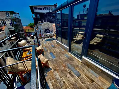 a balcony with a wooden table and chairs on a ship at Golden Arrow Hotel in Istanbul
