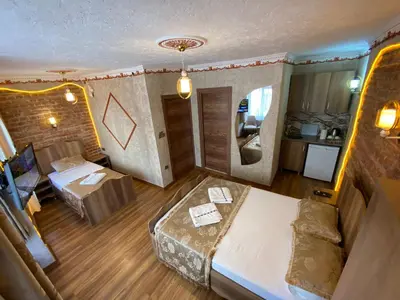 a hotel room with a bed and a couch at Golden Arrow Hotel in Istanbul