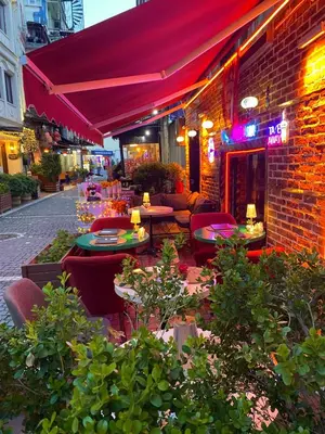 a restaurant with tables and chairs and a brick building at Golden Arrow Hotel in Istanbul