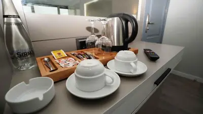 a kitchen counter with two cups and saucers on it at AURA MARINA HOTEL in Istanbul