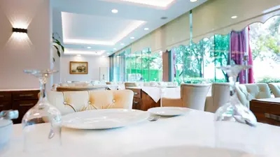 a dining room with white tables and chairs at AURA MARINA HOTEL in Istanbul