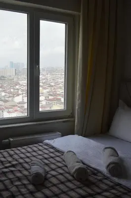 a bedroom with a bed with a large window at Classic Suite MS34 in Istanbul