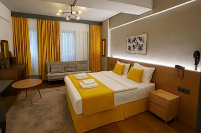 a hotel room with a large bed and a chair at Aleksandr Pera Hotel in Istanbul