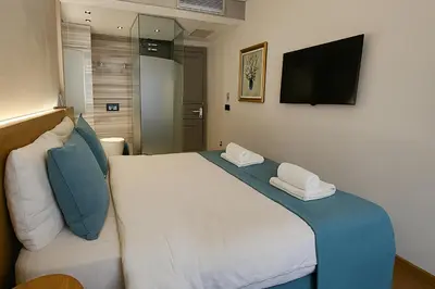 a bedroom with a large bed with two pillows on it at Aleksandr Pera Hotel in Istanbul