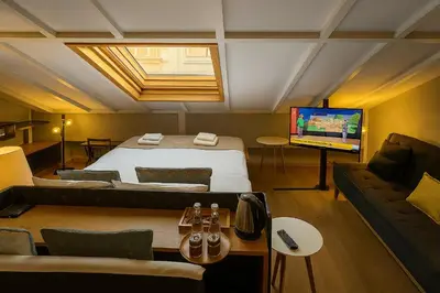 a bedroom with a bed and a couch and a television at Aleksandr Pera Hotel in Istanbul