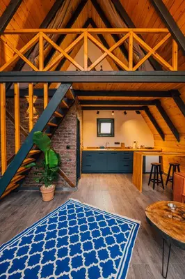 an attic room with a blue rug on the floor at Dark Sapanca in Sapanca