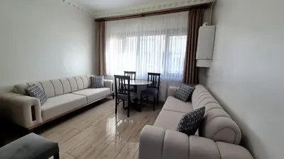 a living room with a couch and a table and chairs at Cihangir Flat in Istanbul
