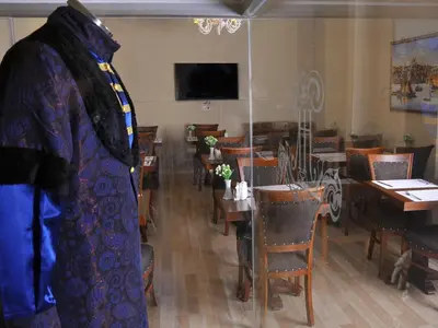 a mannequin in a room with tables and chairs at Divani Ali Hotel in Istanbul