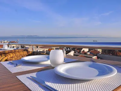 a table with plates and utensils on a cruise ship at Divani Ali Hotel in Istanbul