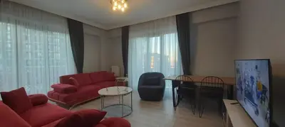a living room with a red couch and a table at GANİGAR alibeyköy in Istanbul
