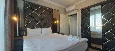 a bedroom with a large white bed with slippers on it at GANİGAR alibeyköy in Istanbul