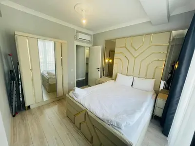 a bedroom with a large bed with a wooden headboard at GANİGAR alibeyköy in Istanbul