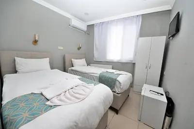 a hotel room with two beds and a window at GRAND Deniz Hotel in Istanbul