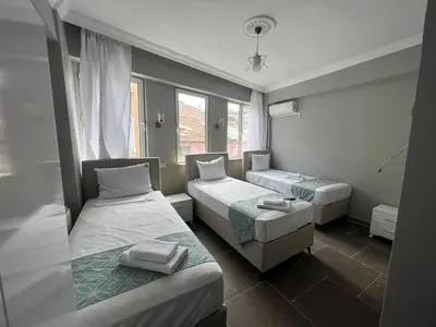 a hotel room with two beds and a window at GRAND Deniz Hotel in Istanbul