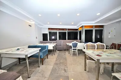 a dining room with tables and chairs and tablesktop at GRAND Deniz Hotel in Istanbul