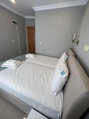 a bed with a pillow on it in a room at GRAND Deniz Hotel in Istanbul