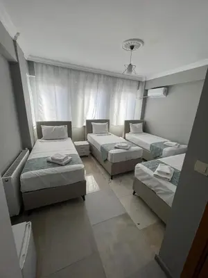 a room with three beds and a couch at GRAND Deniz Hotel in Istanbul