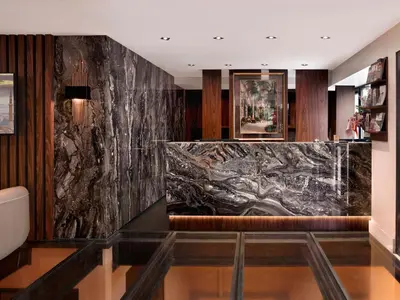 a lobby with a black marble wall at Shining Star Hotel in Istanbul