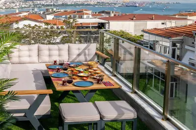 a table and chairs on a balcony with a view at Monnas Suite in Istanbul