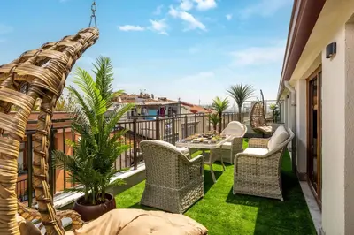 a patio with chairs and a table on a balcony at Monnas Suite in Istanbul