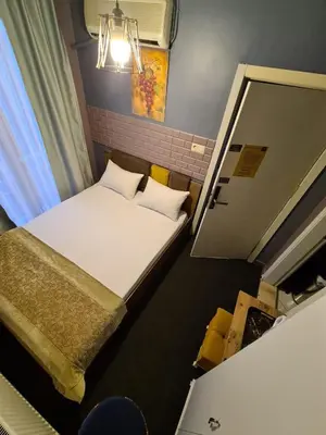 a small room with two beds and a window at Retro Suites in Istanbul