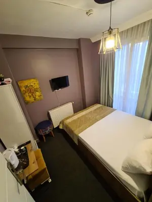 a bedroom with a large bed and a window at Retro Suites in Istanbul