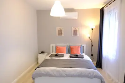 a bedroom with a large bed with orange pillows at Cactus Suites in Istanbul