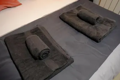 two rolled up towels sitting on top of a bed at Cactus Suites in Istanbul