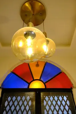 a chandelier hanging from a ceiling with a stained glass window at Cactus Suites in Istanbul