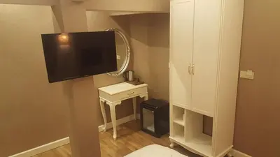 a small bathroom with a television and a mirror at Sun Comfort Hotel in Istanbul