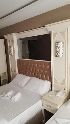 a bed with two white towels on top of it at Sun Comfort Hotel in Istanbul