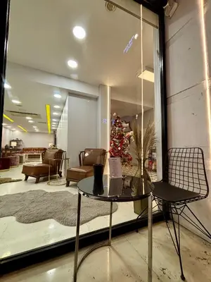 a room with a table and a christmas tree in a store at Wame Suite Hotel Nisantasi in Istanbul