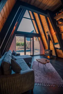 a living room with a couch and a fireplace at KARMATTE BUNGALOW in Kartepe