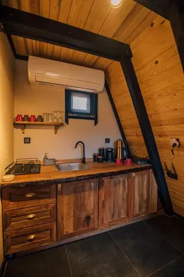 a kitchen with a sink and a wooden ceiling at KARMATTE BUNGALOW in Kartepe