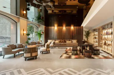 a lobby with a couch and chairs and a table at Burdock Hotel Istanbul, Autograph Collection in Istanbul