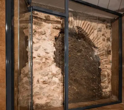 a glass window in front of a stone wall at Marius Hotel in Istanbul