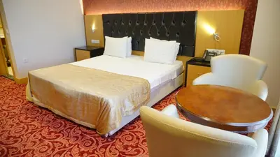 a hotel room with a bed and a table and chairs at Vois Hotel Atasehir & SPA in Istanbul