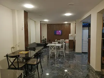 a dining room with tables and chairs and a tv at Grand Kybele Hotel in Istanbul