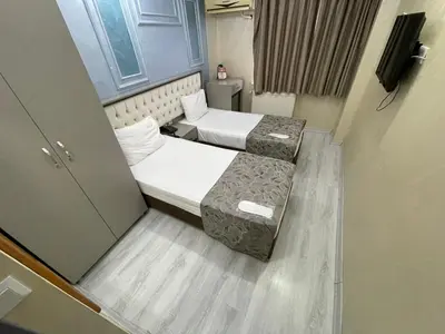 a small room with two beds in a room at Grand Kybele Hotel in Istanbul