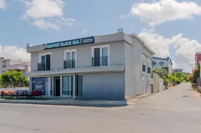 a white building on the side of a street at Airport Black Sea Hotel & Restaurant in Arnavutköy