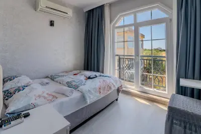 a bedroom with a bed and a large window at Airport Black Sea Hotel & Restaurant in Arnavutköy