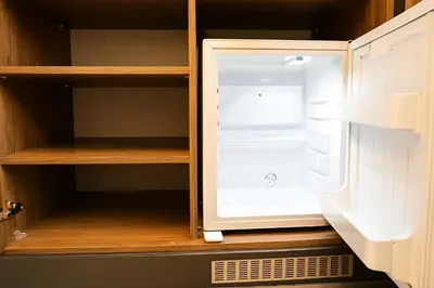 an empty refrigerator door is open in a cabinet at CALENBERG HOTEL in Istanbul