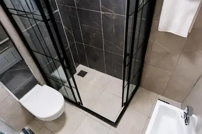 a bathroom with a toilet and a shower at CALENBERG HOTEL in Istanbul
